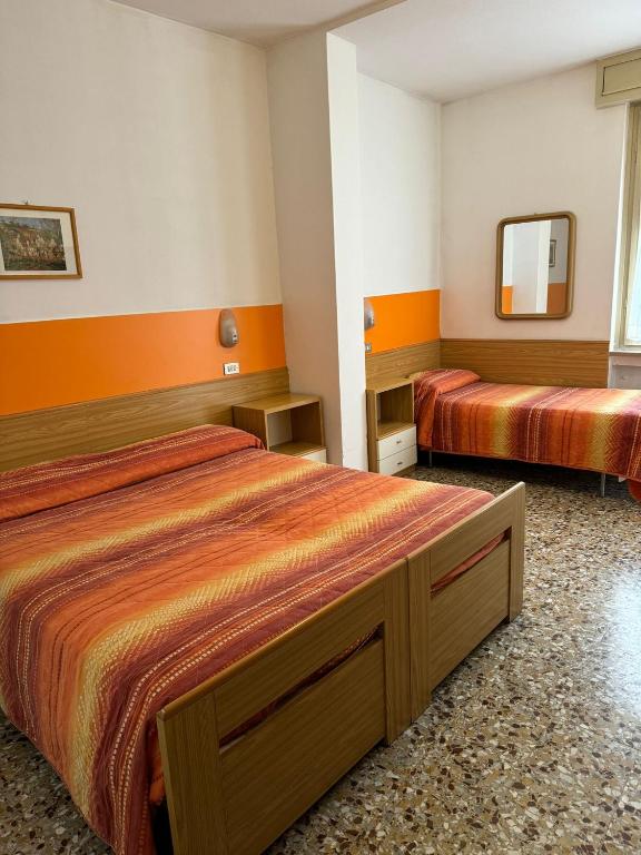Postel nebo postele na pokoji v ubytování Hotel Garnì Capinera
