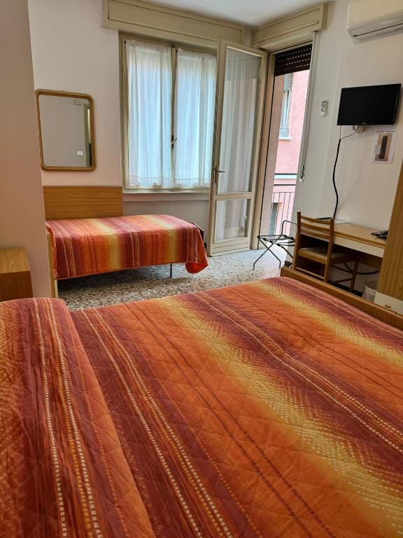 Postel nebo postele na pokoji v ubytování Hotel Garnì Capinera