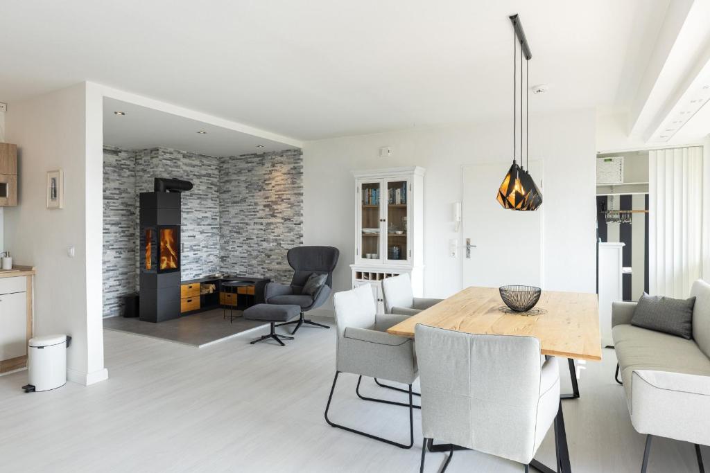 a dining room and living room with a table and chairs at Golfresidenz Wohnung 211 in Grömitz