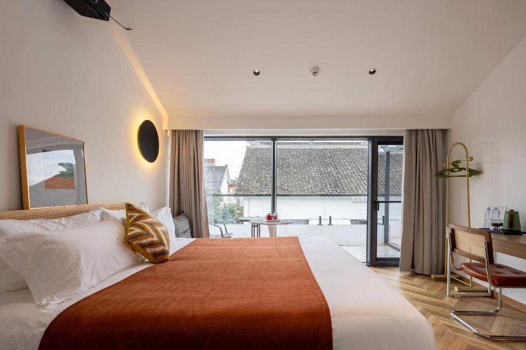 Postel nebo postele na pokoji v ubytování Suzhou Zhouzhuang Slowlife River View lnn