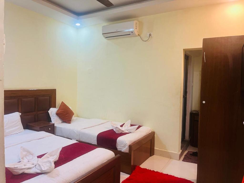 a hotel room with two beds and a heater at Hotel Suramma Pvt. Ltd. in Lumbini