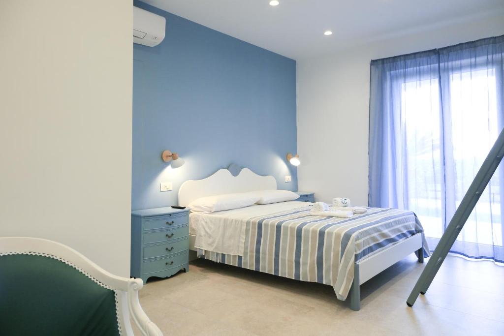 Ένα ή περισσότερα κρεβάτια σε δωμάτιο στο Villa Del Gaudio Rooms & Apartments
