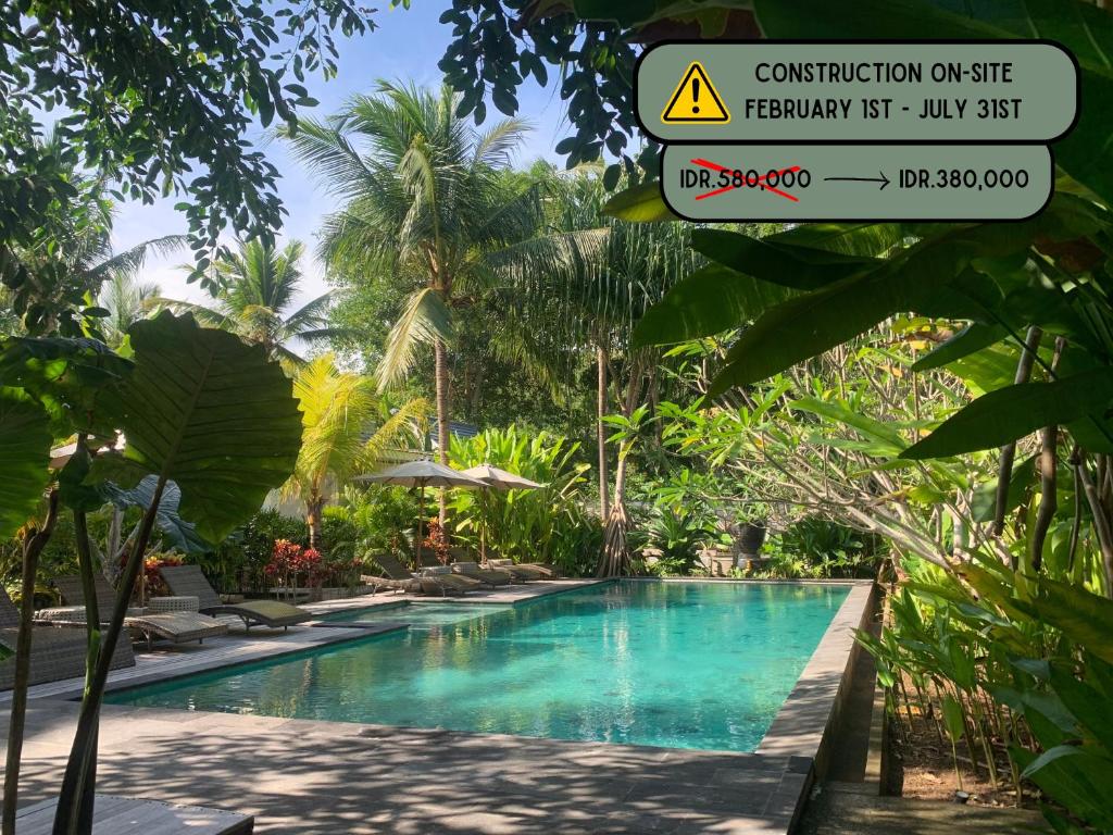 a sign next to a swimming pool in a resort at Kulkul Bungalow in Nusa Penida