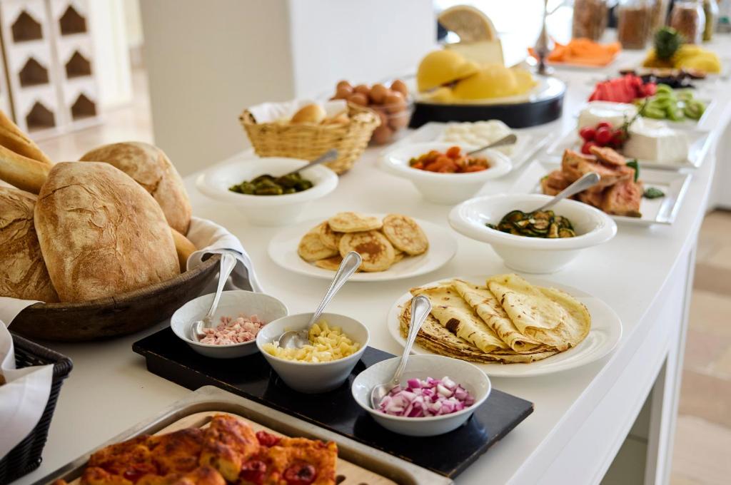 a buffet with many different types of food on a table at La Casa E Il Mare, Private Bay Hotel in Mattinata