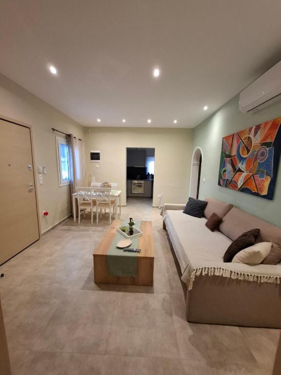a large living room with a couch and a table at Limone d'oro in Artemida