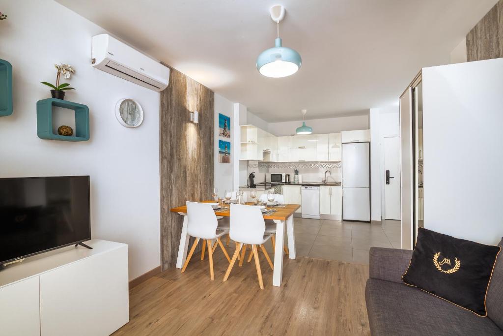 a kitchen and living room with a table and chairs at Playa Paraiso apartment in Playa Paraiso