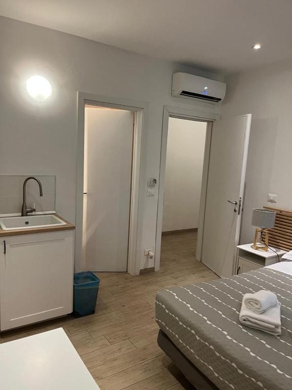 a bathroom with a bed and a sink in a room at My Bnb Pisa in Pisa