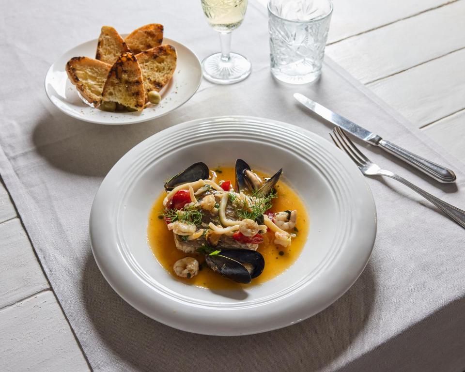 a plate of food on a table with a plate of food at La Casa E Il Mare, Private Bay Hotel in Mattinata