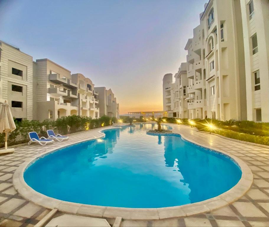 a large swimming pool in the middle of a building at Sahl Hasheesh, El Andalous by sea and pool view, private beach in Hurghada