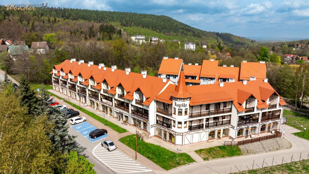 an aerial view of a large building with an orange roof at Wonder Home - Wyszyńskiego 9 blisko deptaka miejskiego, placu zabaw i Parku Zdrojowego in Świeradów-Zdrój