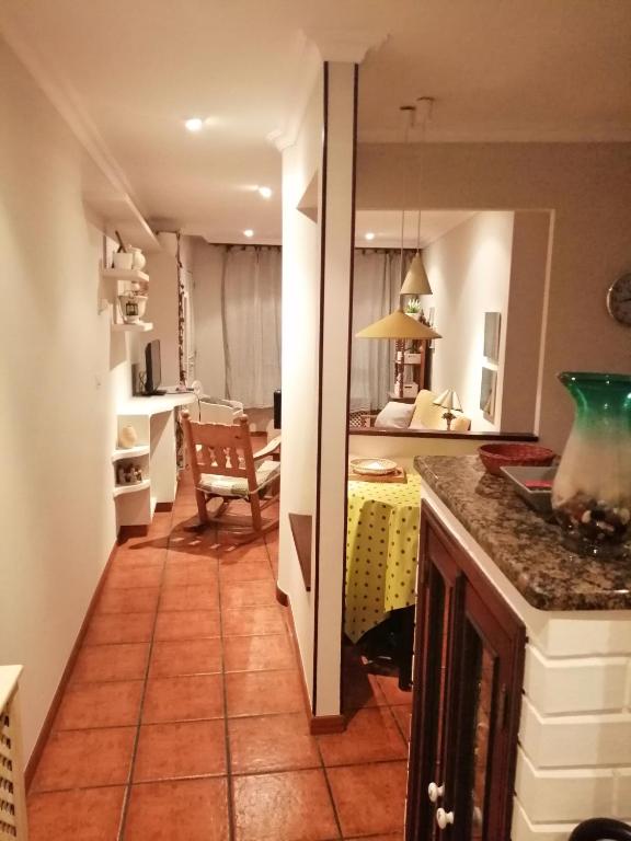 a kitchen with a counter and a table in a room at O Piso dos Avós in A Guarda