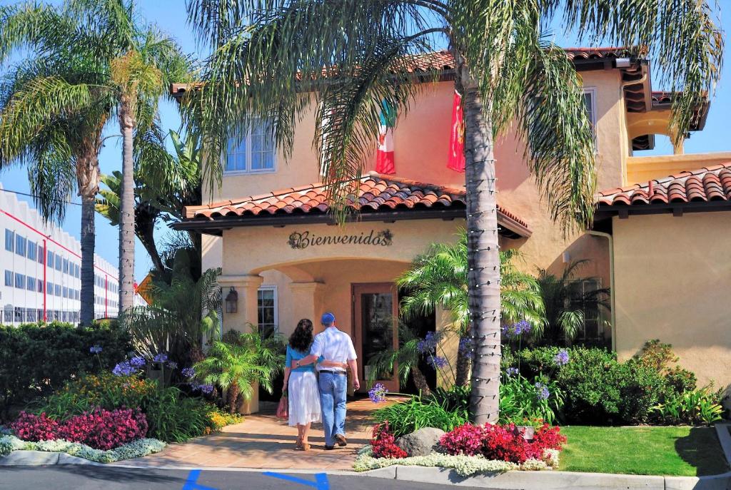a man and woman walking into a house at Old Town Inn in San Diego