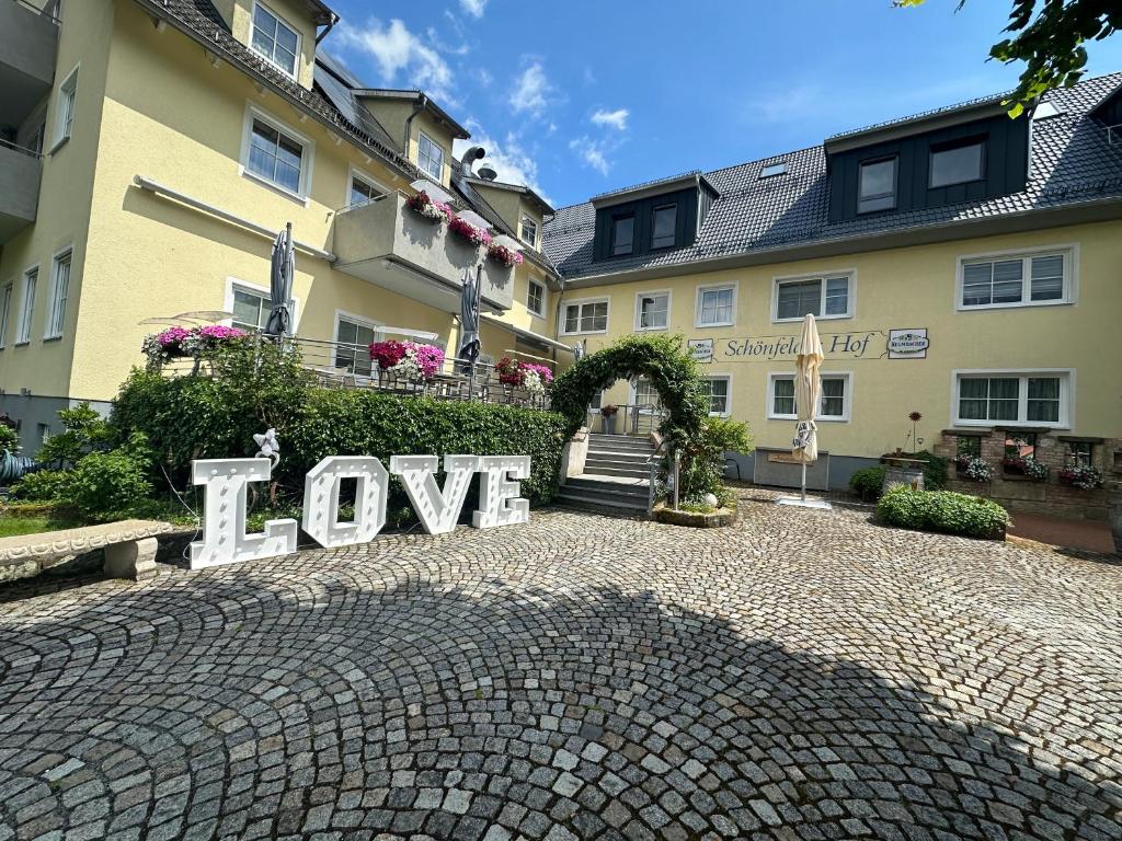 a sign that says love in front of a building at Landhaus Schönfelder Hof in Hollfeld