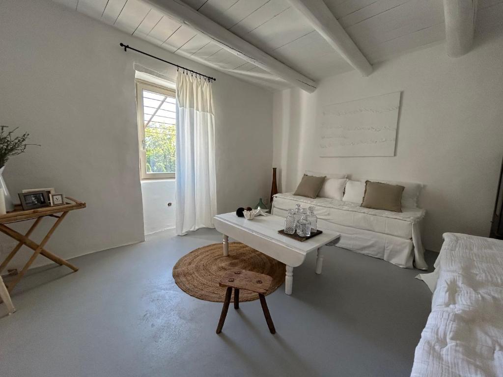 - un salon blanc avec un lit et une table dans l'établissement La Maison de Victor, à La Bruguière