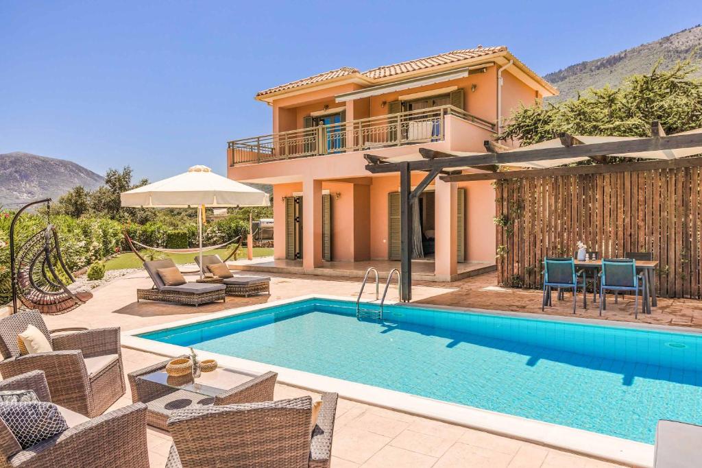 a villa with a swimming pool and a house at Villa Melissanthi in Chaliotata