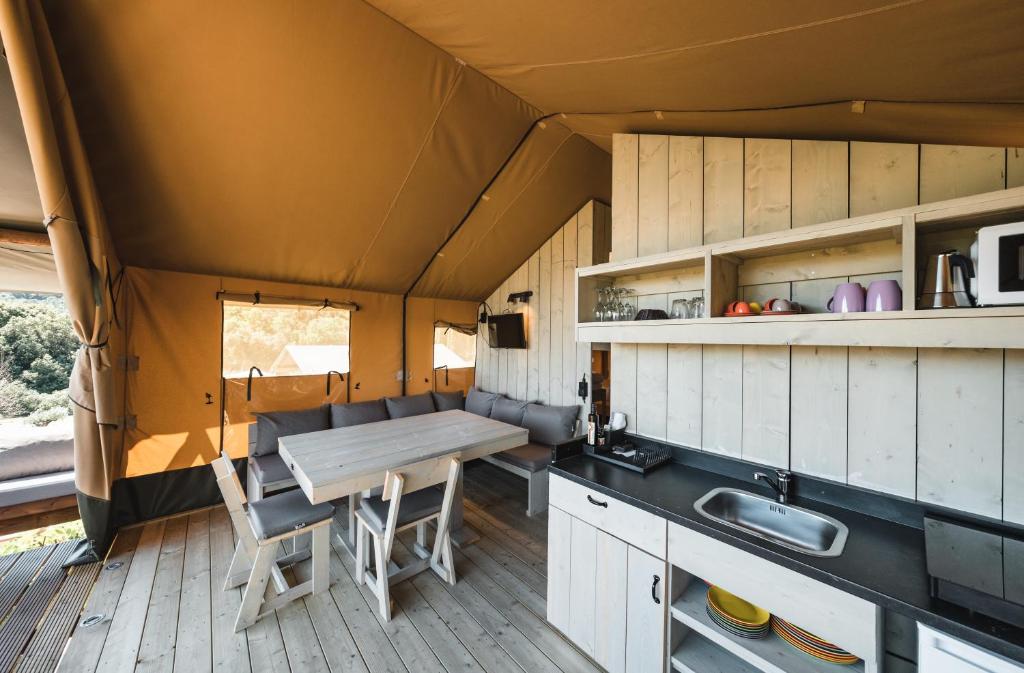 A kitchen or kitchenette at Glamping Le Tegole