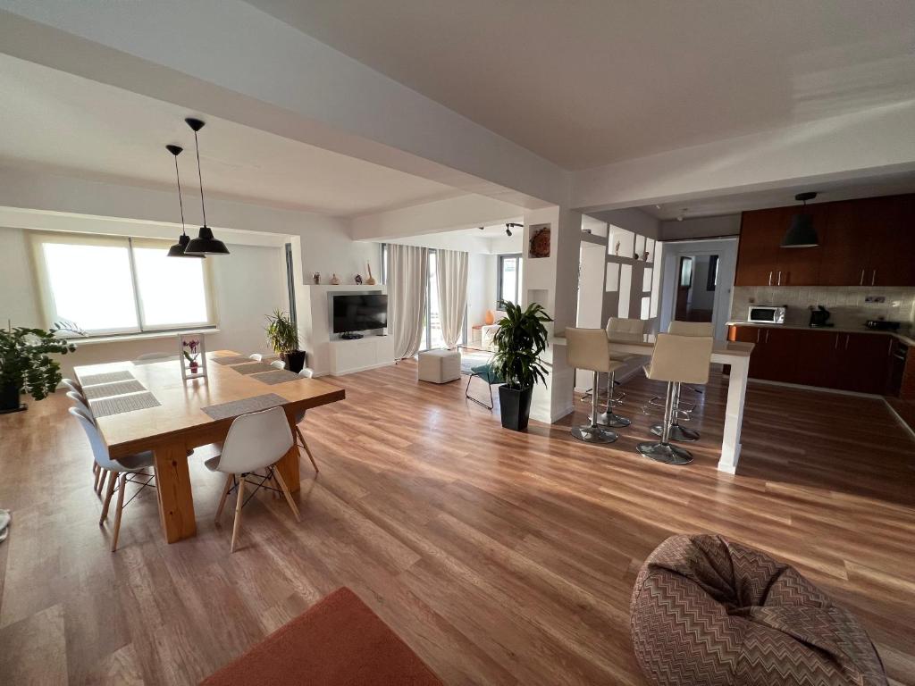 a living room with a table and a dining room at Julipapas Gardens in Paphos