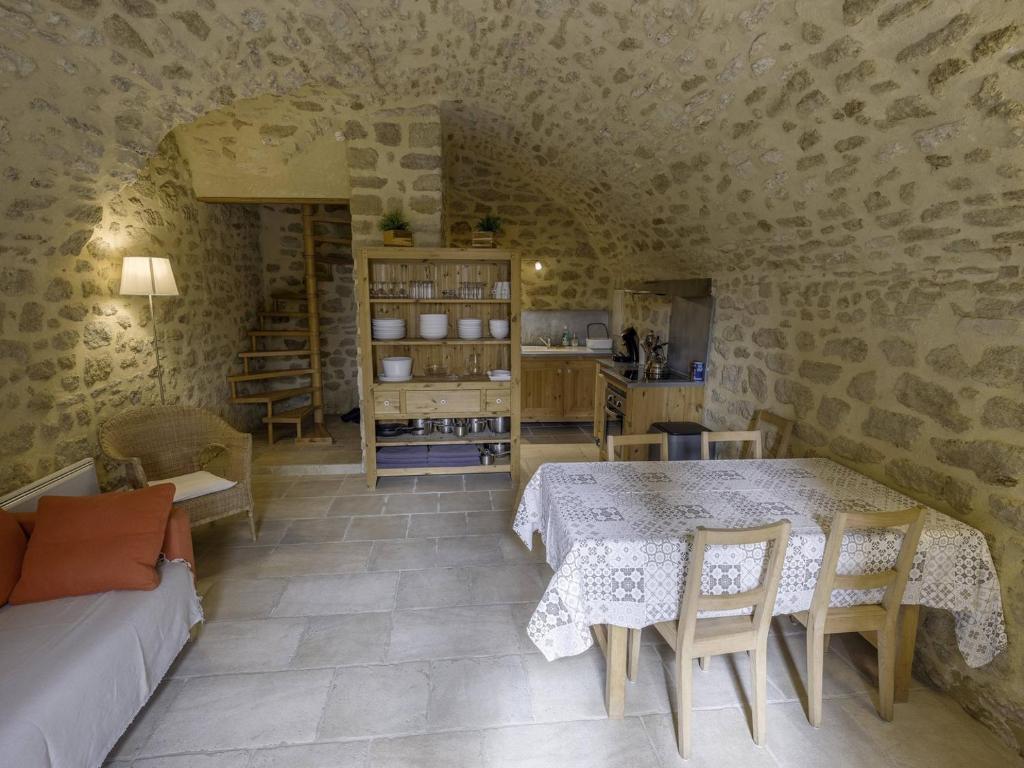 a living room with a table and chairs and a couch at Voûte in Colonzelle