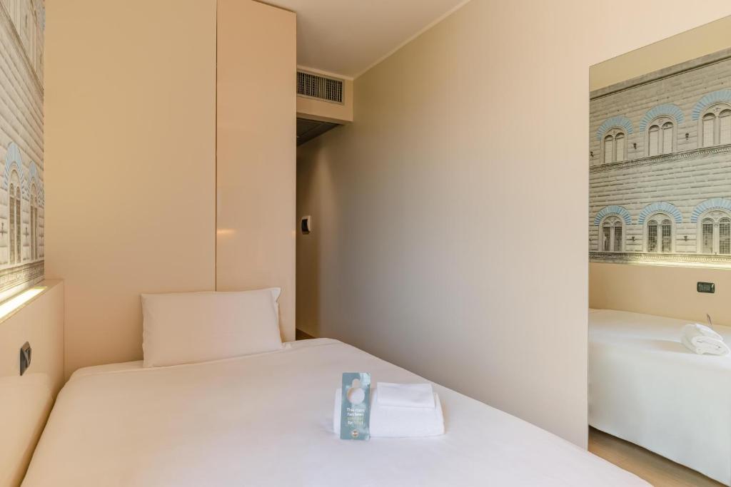 Postel nebo postele na pokoji v ubytování B&B Hotel Firenze City Center