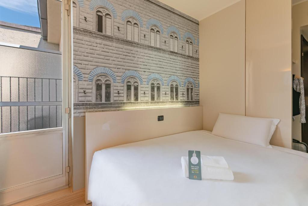 Postel nebo postele na pokoji v ubytování B&B Hotel Firenze City Center