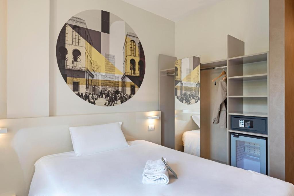 a hotel room with a bed and a tv at B&B Hotel Milano Central Station in Milan