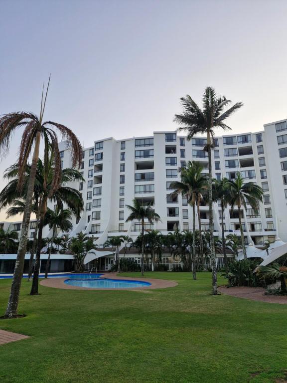 a large building with palm trees in a park at Breakers Resort, Umhlanga, 232 in Durban