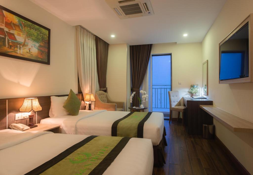 Postel nebo postele na pokoji v ubytování BN Boutique Nha Trang Beach
