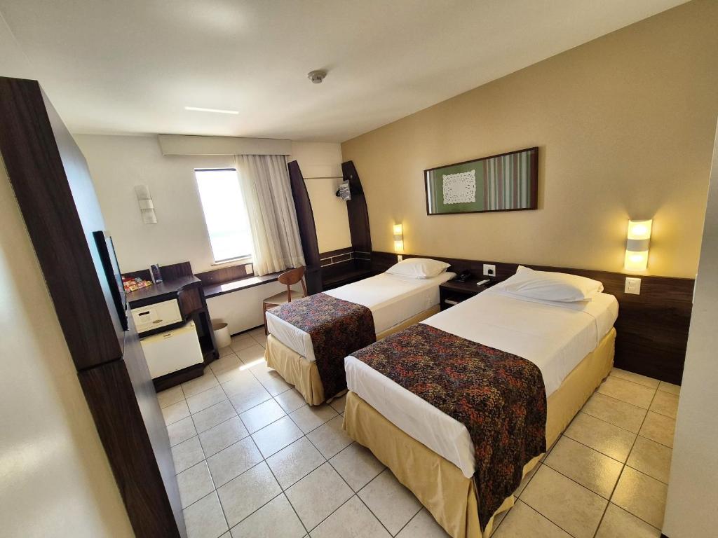 Postel nebo postele na pokoji v ubytování Hotel Sonata de Iracema