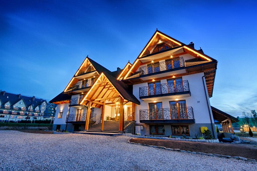 a large house with a gambrel roof at Willa Marti GOLD in Zakopane