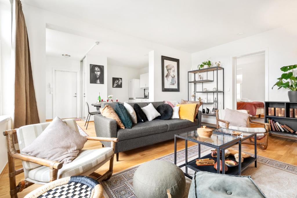 a living room with a couch and a table at Central Big and Bright Resting place in Trondheim