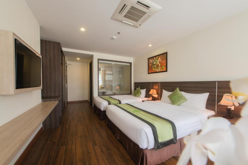 Postel nebo postele na pokoji v ubytování BN Boutique Nha Trang Beach