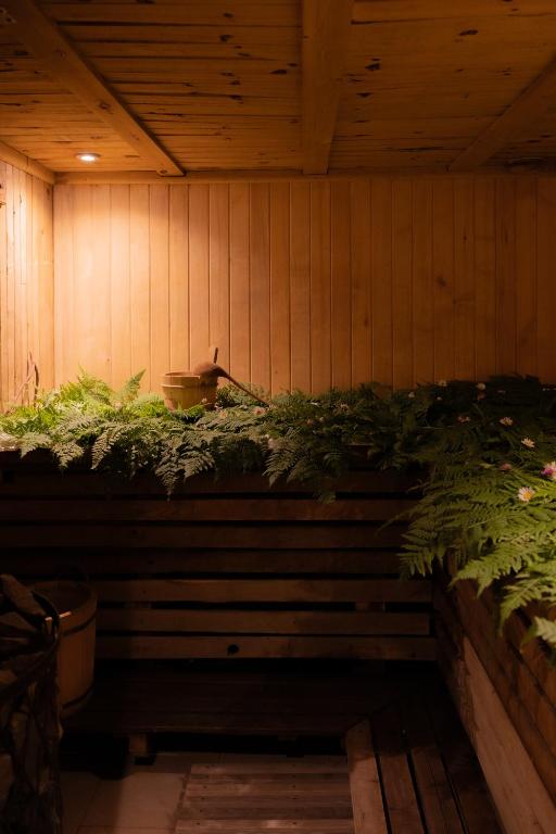 a wooden wall with plants on top of it at Kalna Smīžu pirtiņa in Melturi