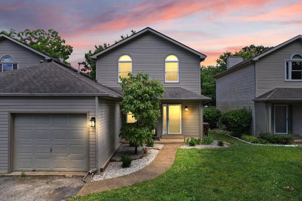 a house with a garage in a yard at 5 Minutes from Hospitals and UK! in Lexington