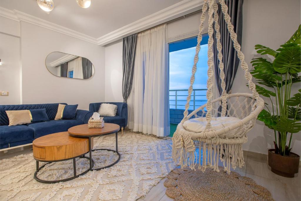 a swing in a living room with a blue couch at Skyline Premium Properties in Alexandria