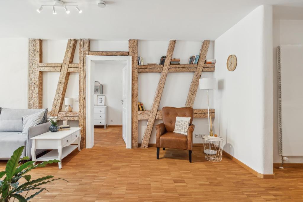 a living room with a bed and a chair at Loft über den Dächern Coburgs in Coburg