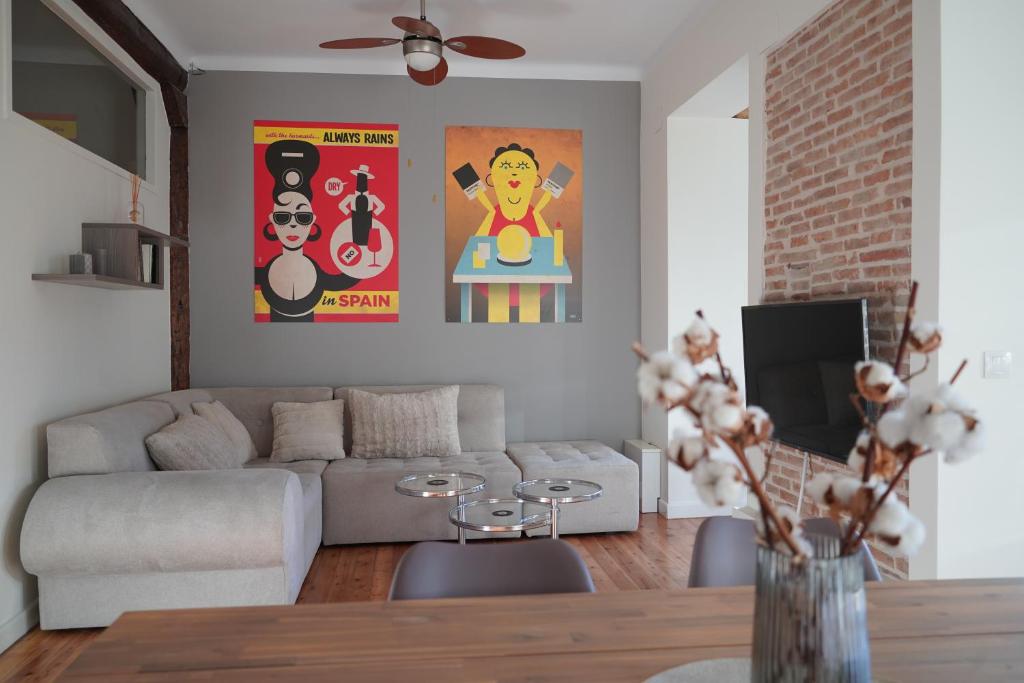 a living room with a couch and posters on the wall at Entre Algodones in Logroño
