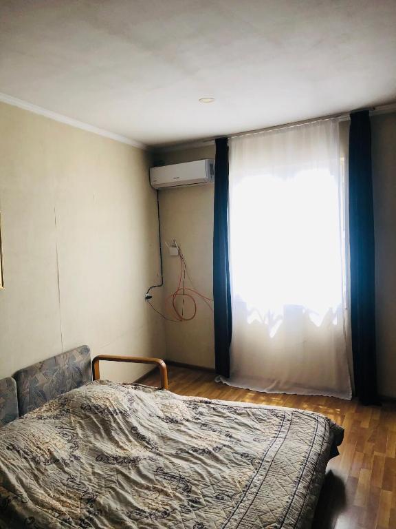 Postel nebo postele na pokoji v ubytování Apartment Zaziashvili 30