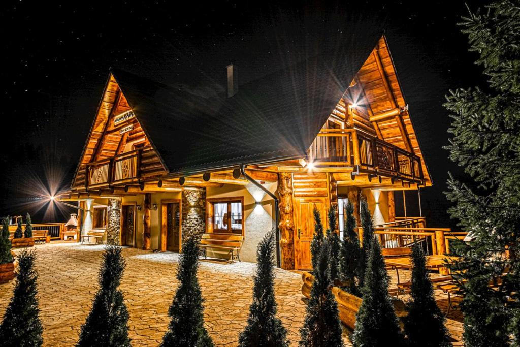 a log cabin at night with the lights on at Chalupa Katka in Dolný Kubín