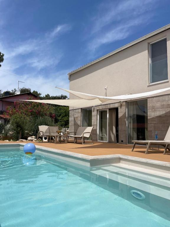 a swimming pool in front of a house at VILLA RITA ARTaTORE in Mali Lošinj