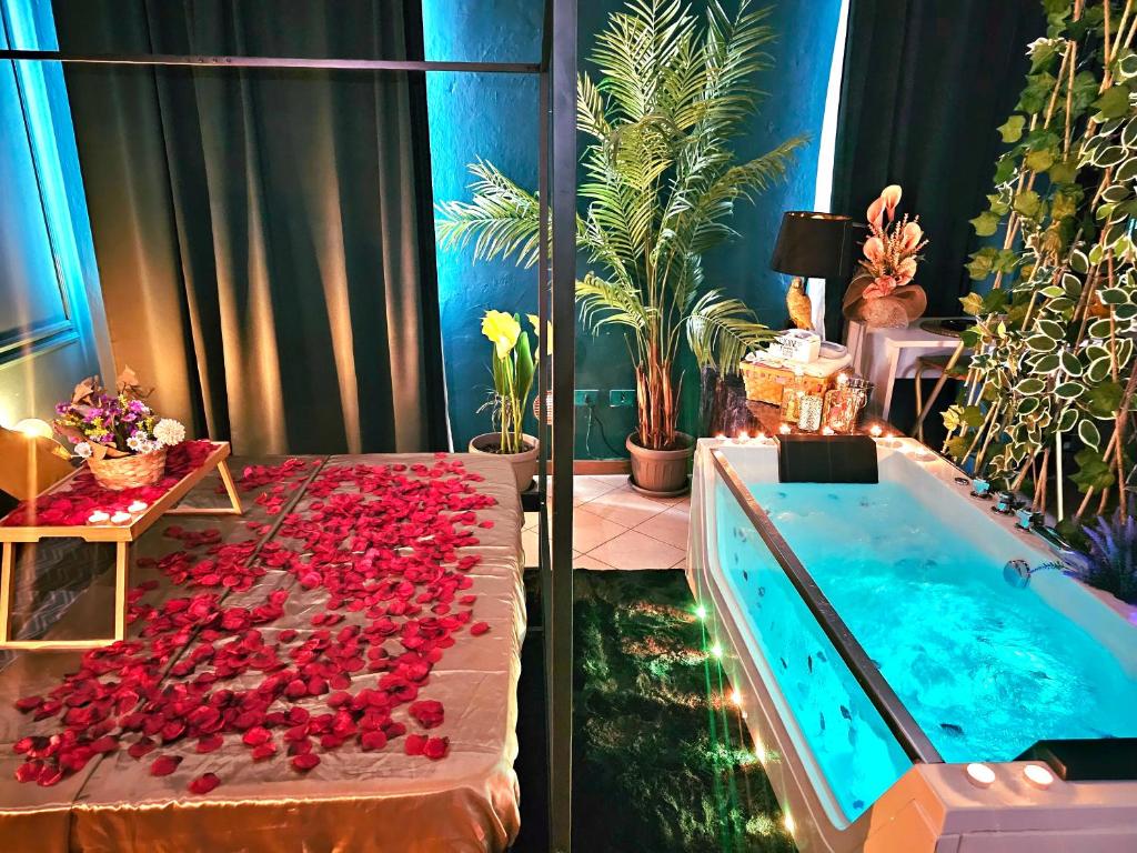 a bathroom with a tub filled with red roses at AMA Esclusive SPA Amore in Ferrara