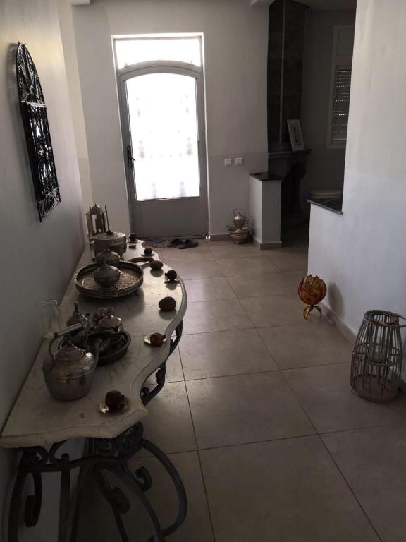 a room with a table with dishes on it at Landelijke Villa Azzemour in Douar Bouidat