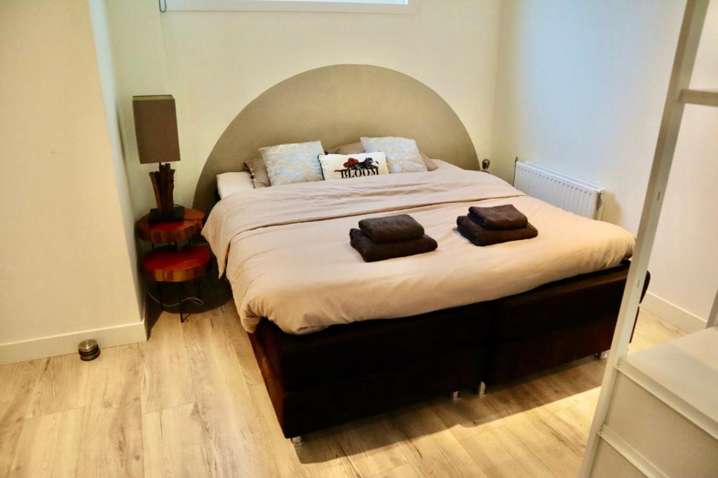 a bedroom with a large bed with two pillows on it at Casa del Queso in Alkmaar