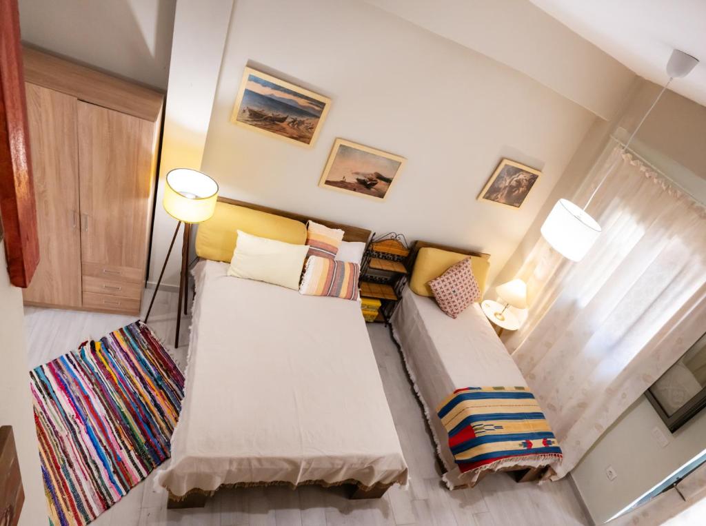 a living room with a couch with colorful pillows at Οdyssey Apartments Lefkas Centrum in Lefkada
