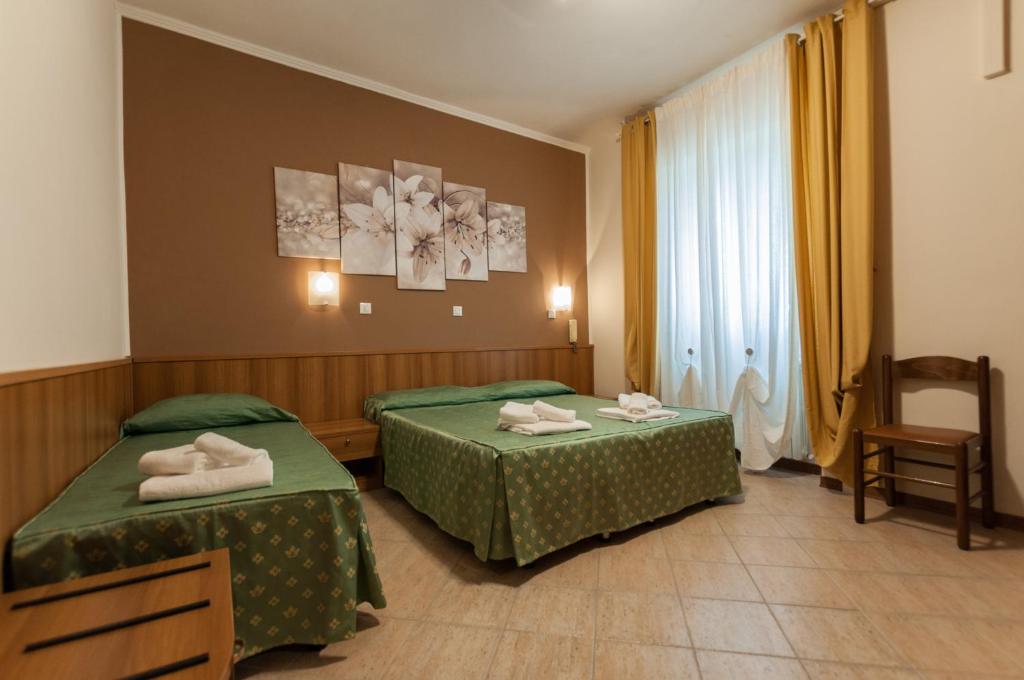 Postel nebo postele na pokoji v ubytování Hotel Orsini