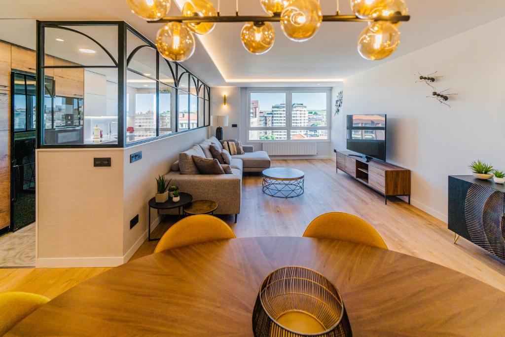 a living room with a table and a couch at Plaza España - Apartamentos Burgos Deluxe in Burgos