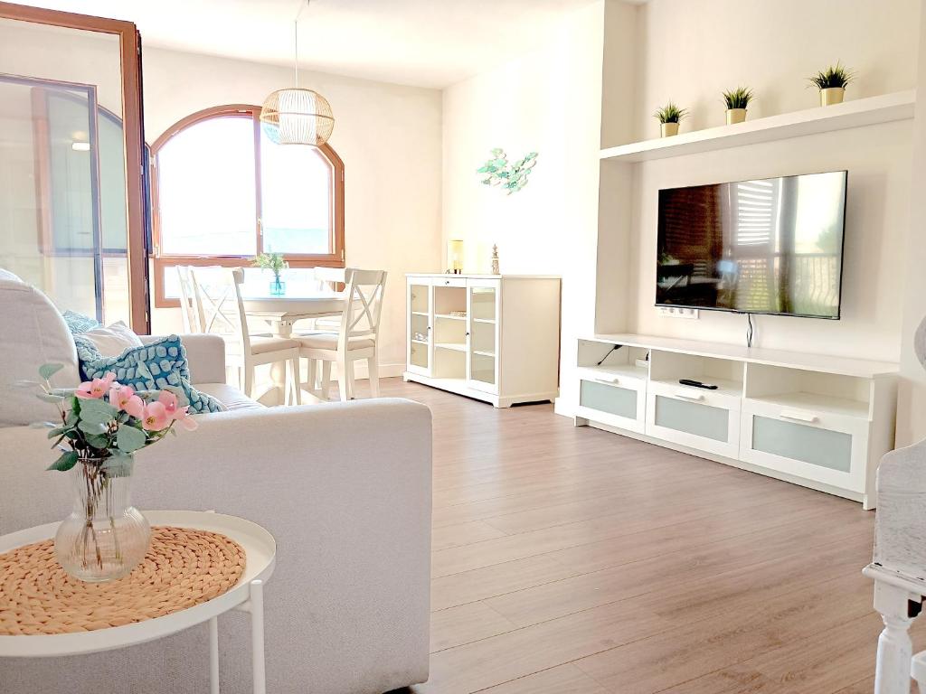 a living room with a couch and a tv at ROYAL BEACH - Appartment with sea view & terrace in Faro de Cullera