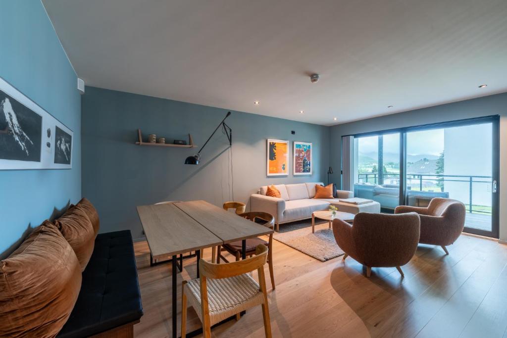 a living room with a couch and a table at Modern Apartment close to Leknes in Leknes