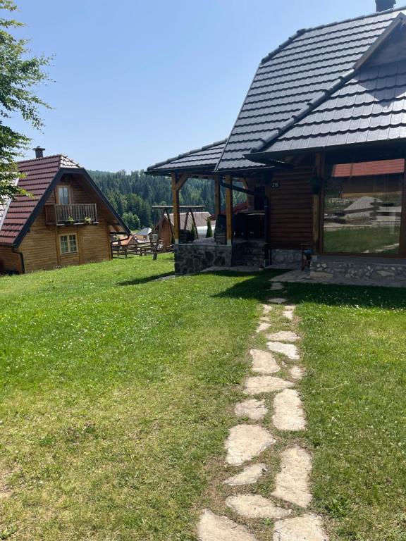 a house with a stone path in front of it at Brvnare Sekulic in Sekulić 