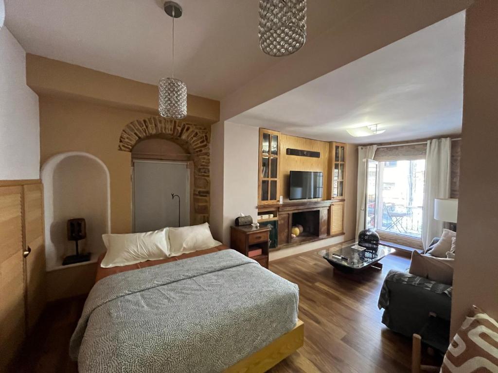 a bedroom with a bed and a living room at Mastixi in Chios
