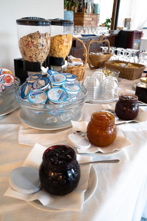 a table topped with donuts and bowls of food at Park Hotel Cilento in Marina di Camerota
